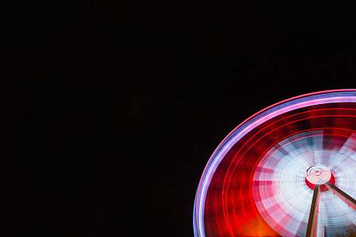 amusement park time lapse photography of ferris wheel during nighttime leisure activities